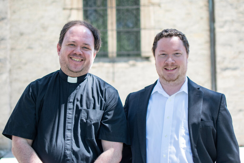 Fr. Nathaniel Romano, left and Andrew Mountin stand outside of St. Joan of Arc Chapel. 