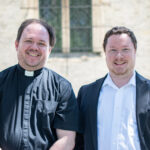 Fr. Nate Romano, left, and Andrew Mountin stand outside of St. Joan of Arc Chapel.