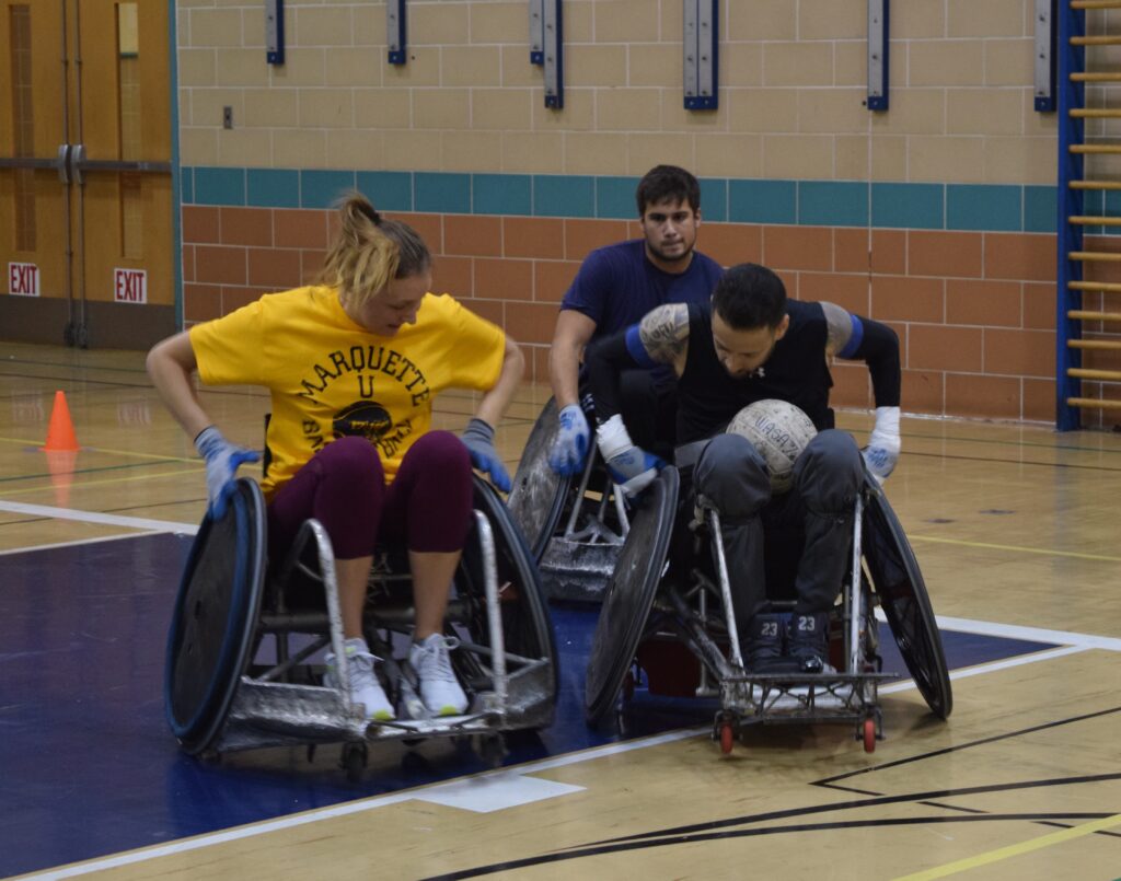 Students play wheelchair rugby. 