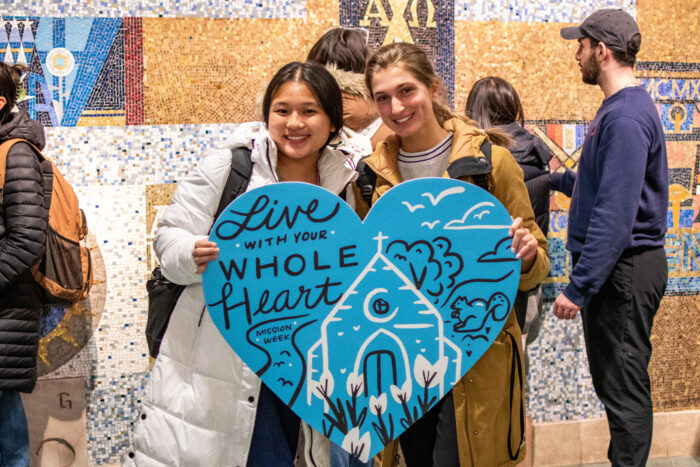 Students holding a sign.