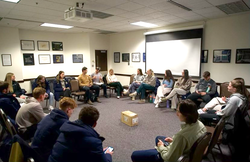 A group of students talking in a circle