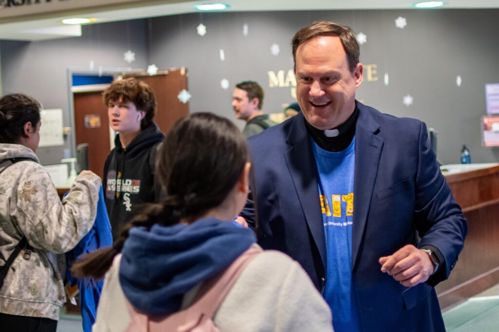 Father Thiede, Jesuits, John Theide, Mission Week 2024, Student, luncheon, students
Rev. John Thiede, vice president for Mission and Ministry, hands out a shirt to a student at the Global Jesuit Luncheon.