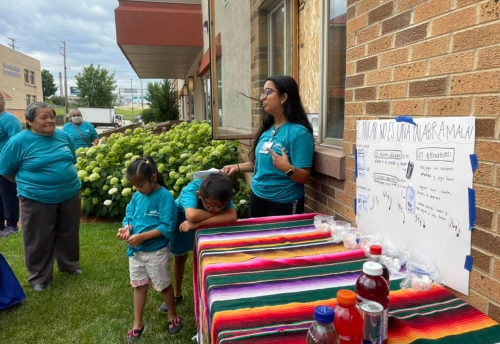 Priya speaking to community members.