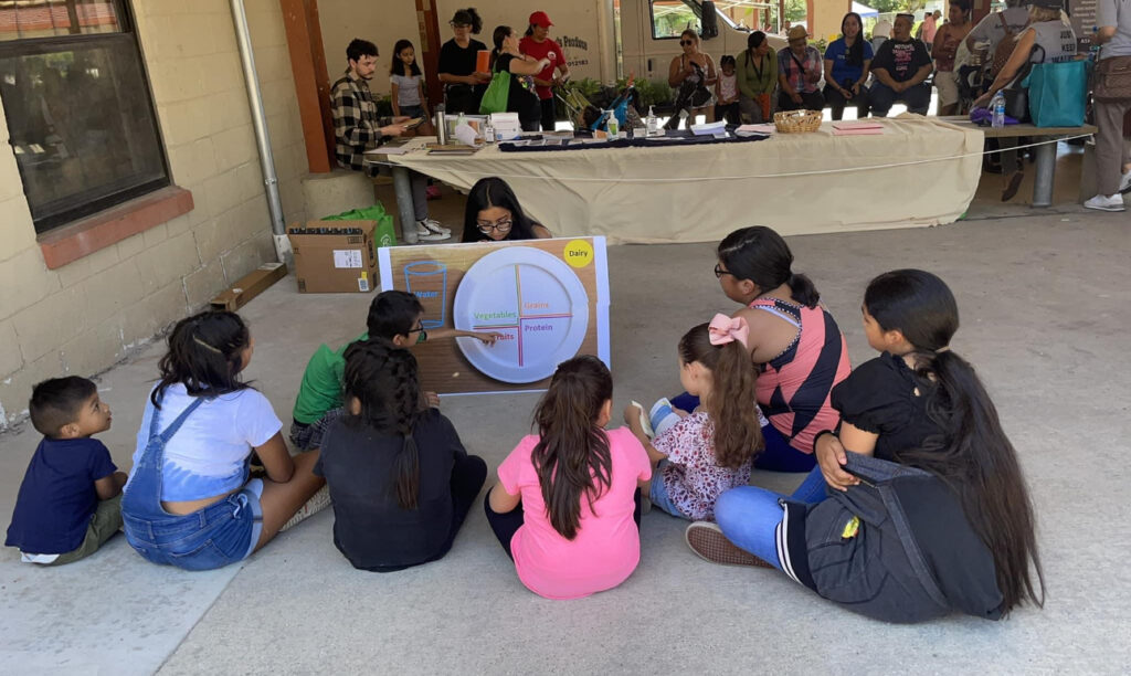 Priya sitting with kids