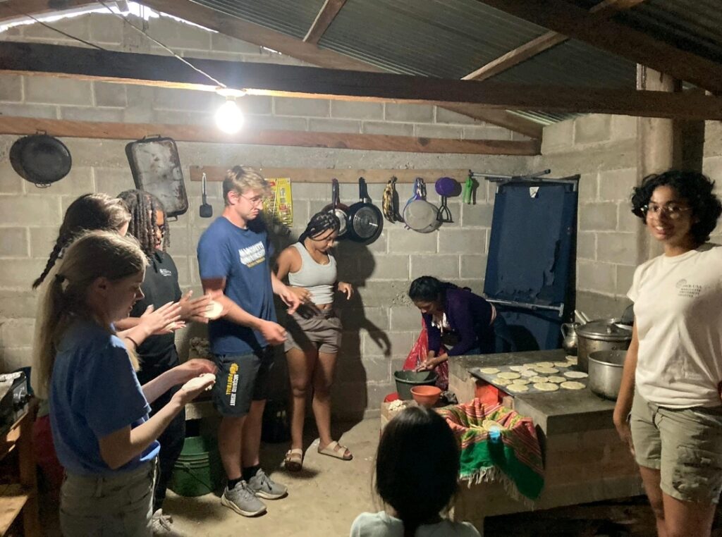 Students and their host work to make homemade tortillas