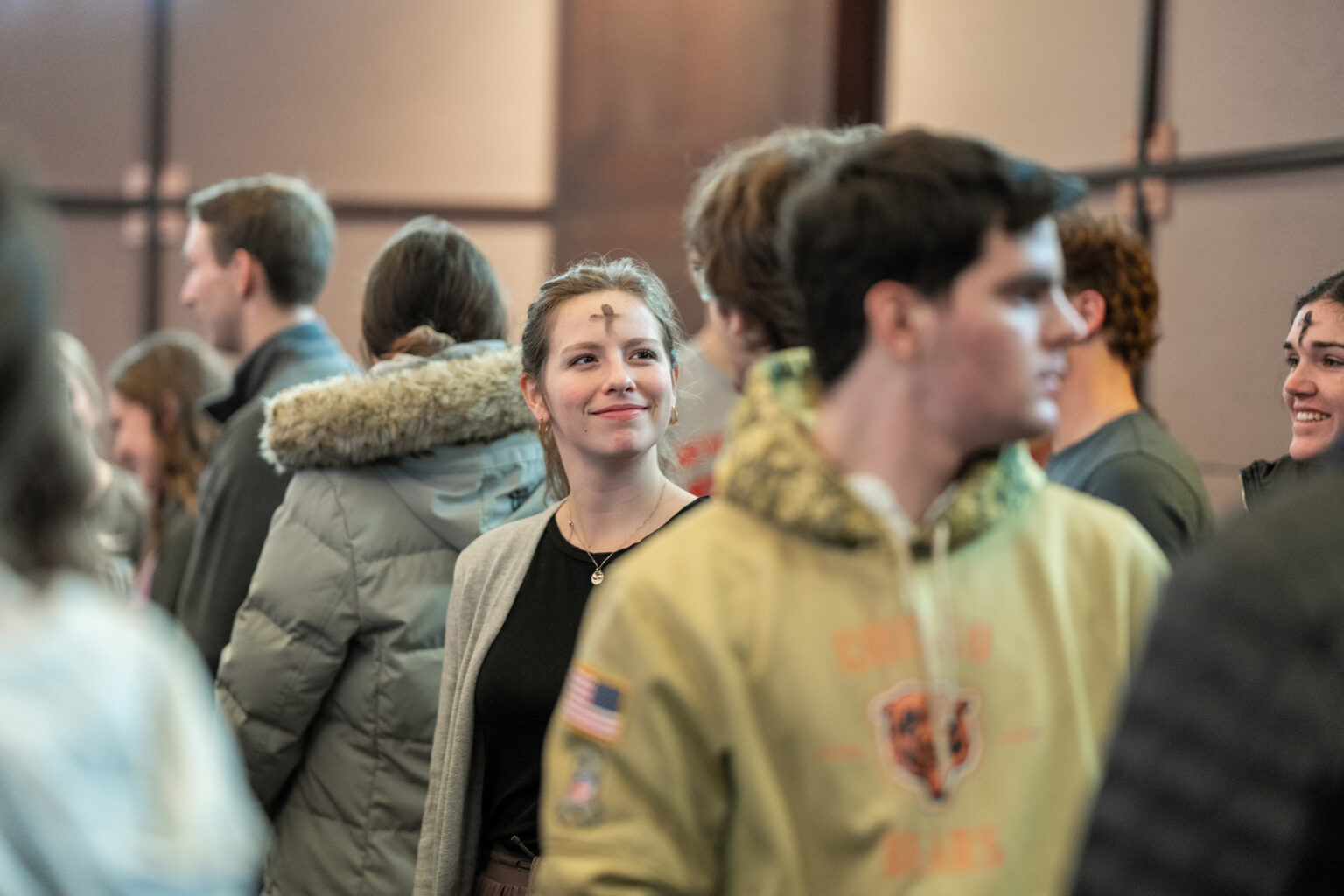 Students receive ashes in the Chapel of the Holy Family.