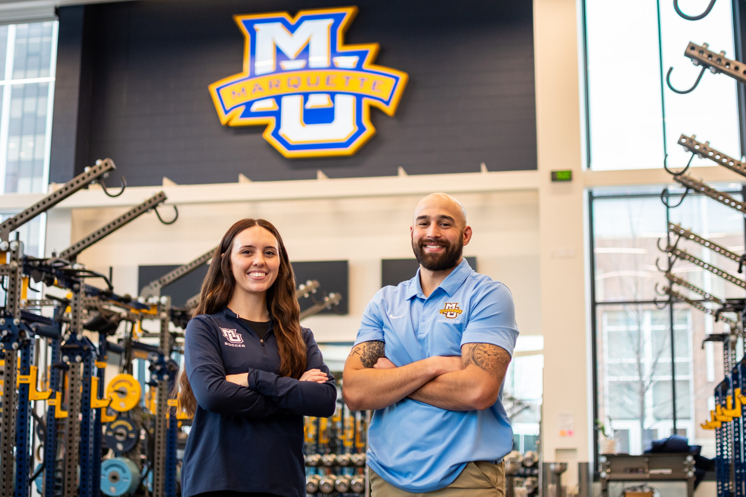 Noel Kruse and Eric Khondaker stand in the AHPRC weight room.