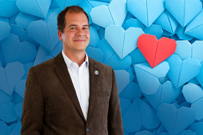 Lots of blue origami paper hearts with a red one over them