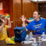 Dr. Ann E. Millard plays with a child at the adaptive sports camp.