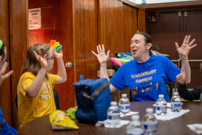 Dr. Ann E. Millard plays with a child at the adaptive sports camp.