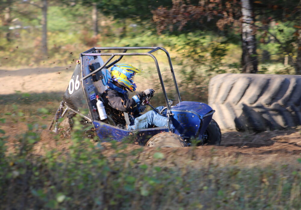 off-road racing vehicle on a dirt track through the woods