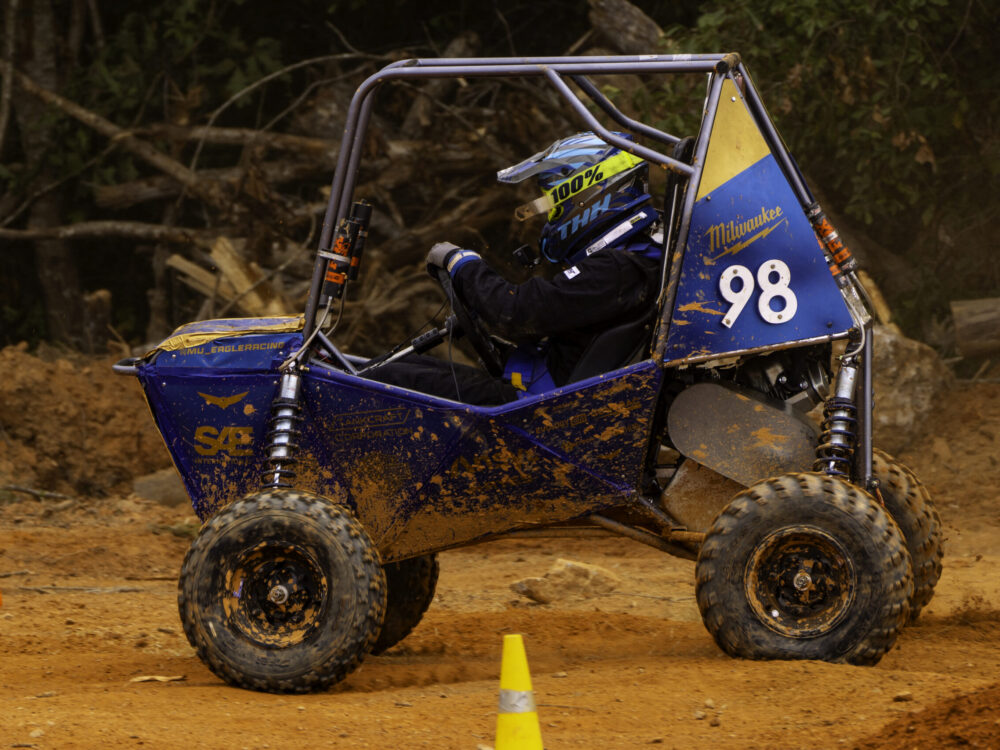 off-road racing vehicle driving on dirt track