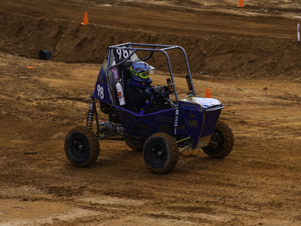 off-road racing vehicle driving on dirt track