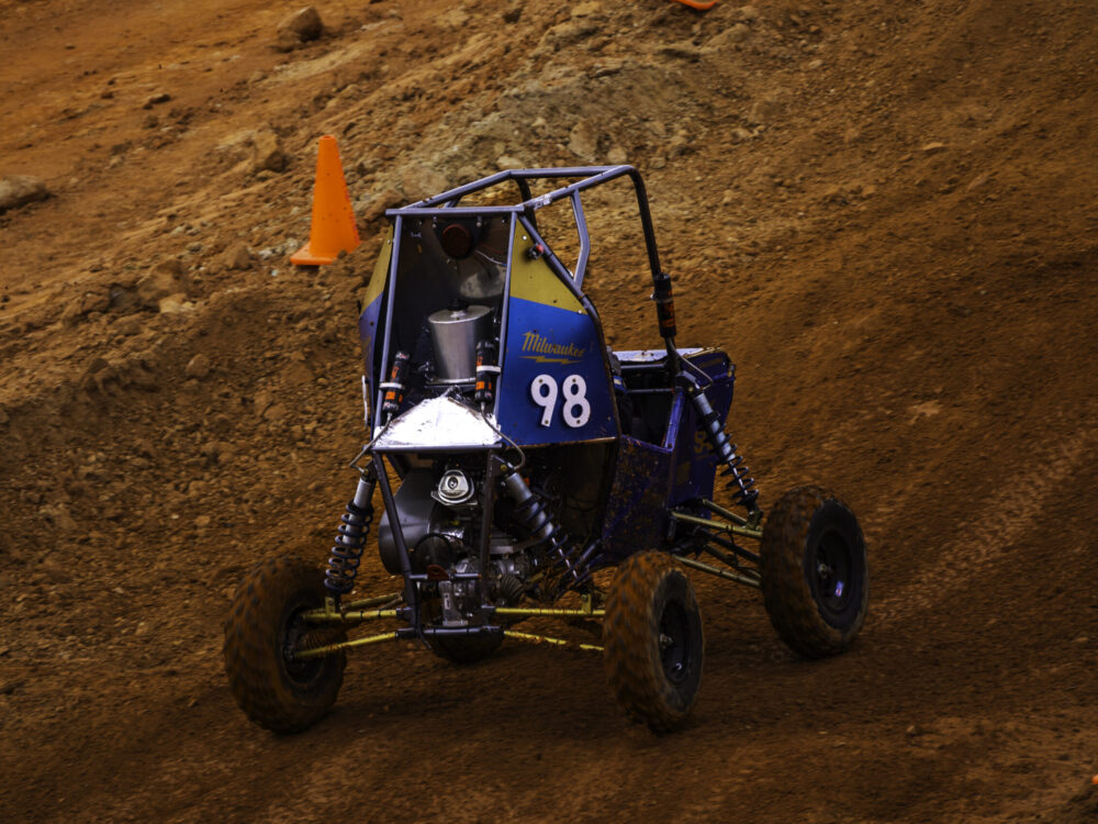 off-road racing vehicle driving on dirt track