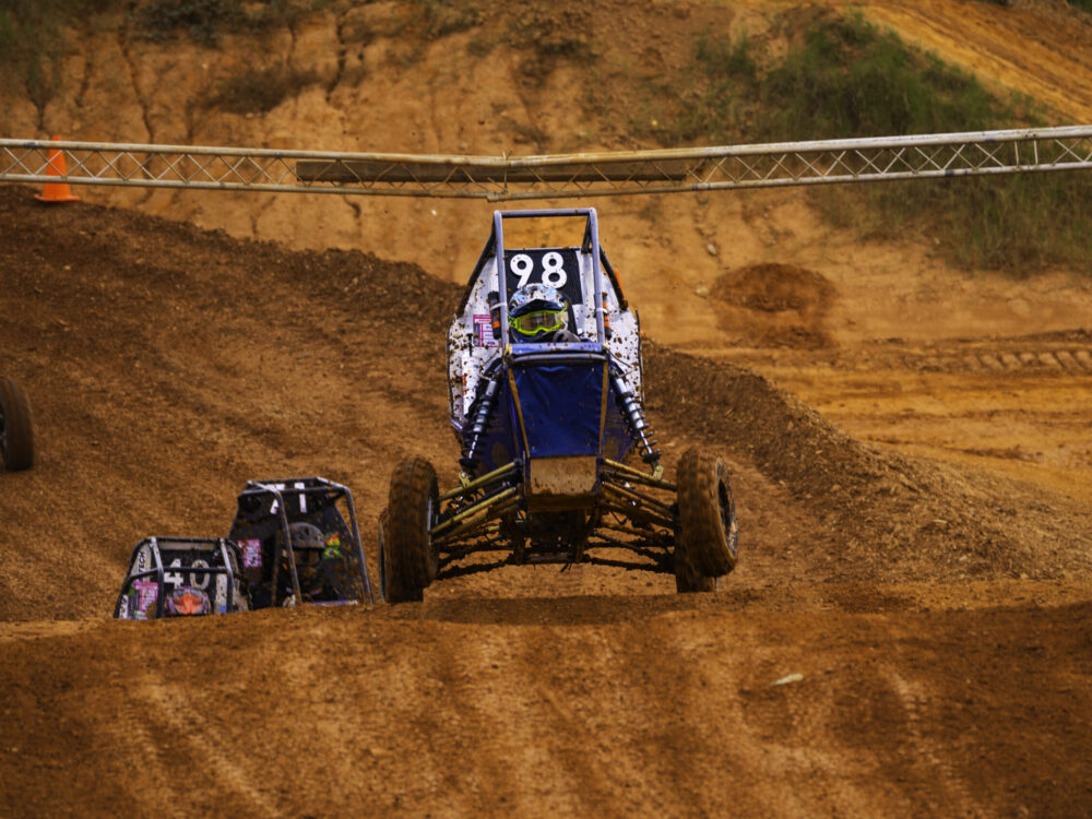 off-road racing vehicle driving on dirt track