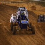 off-road racing vehicle driving on dirt track