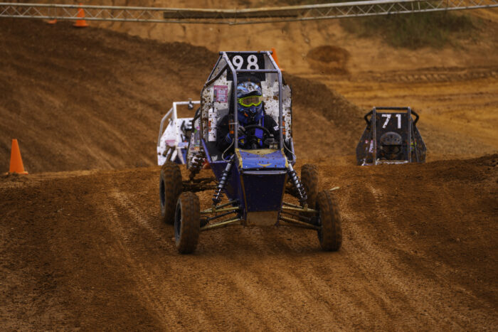 off-road racing vehicle driving on dirt track