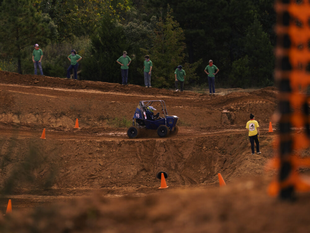 off-road racing vehicle driving on dirt track