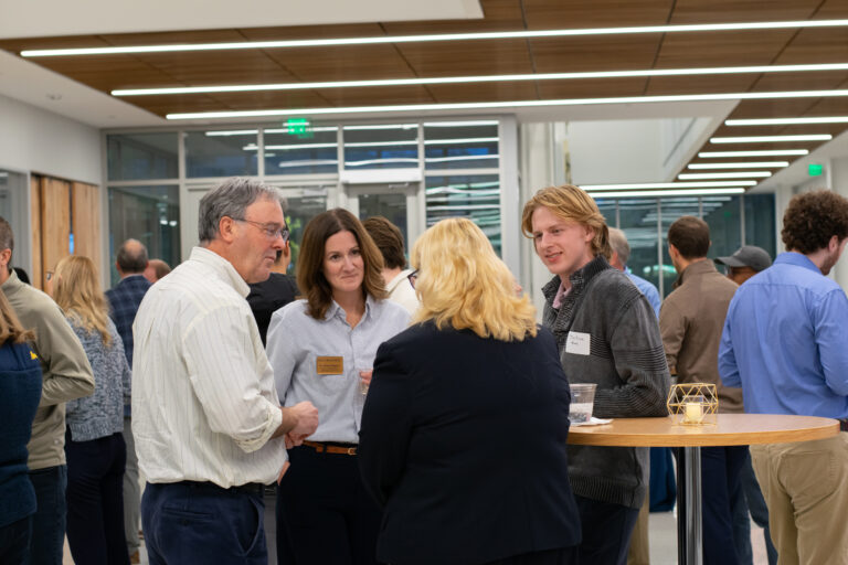 Marquette Business students, faculty, and alumni networking at event
