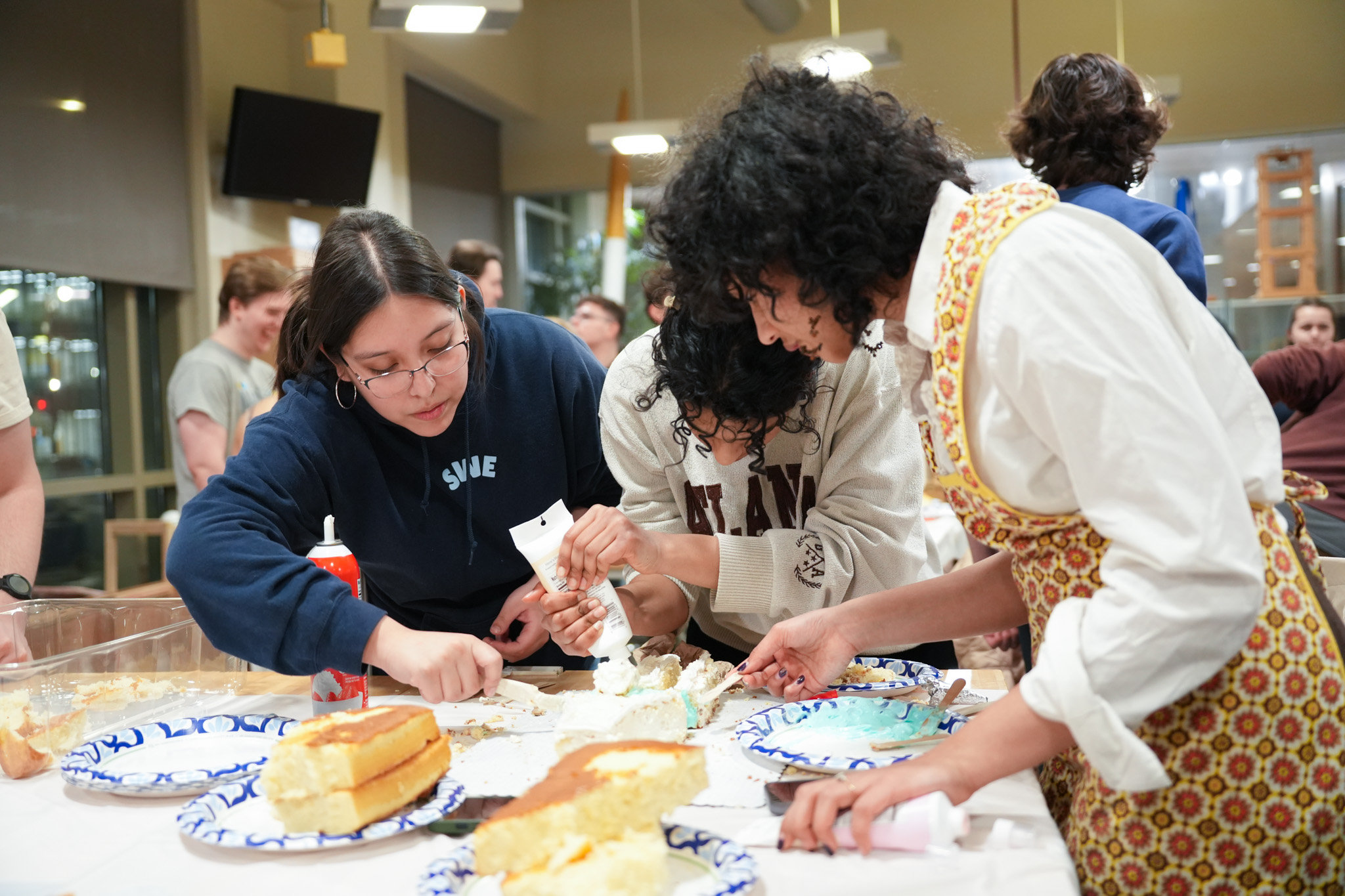 Students collaborating at cake decorating contest