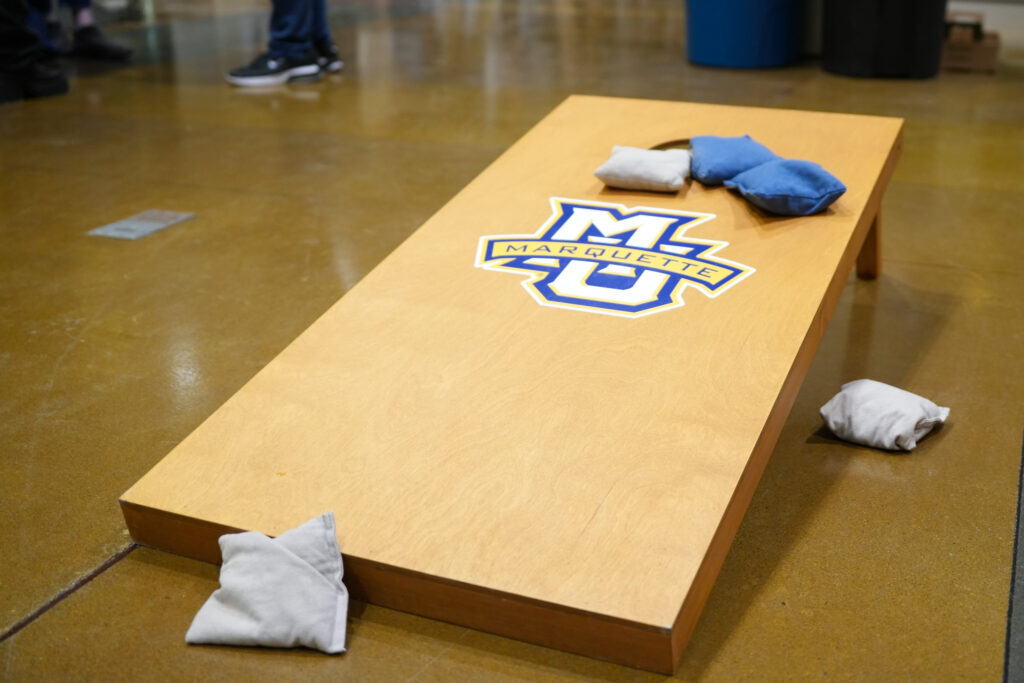 Marquette branded cornhole board at student event