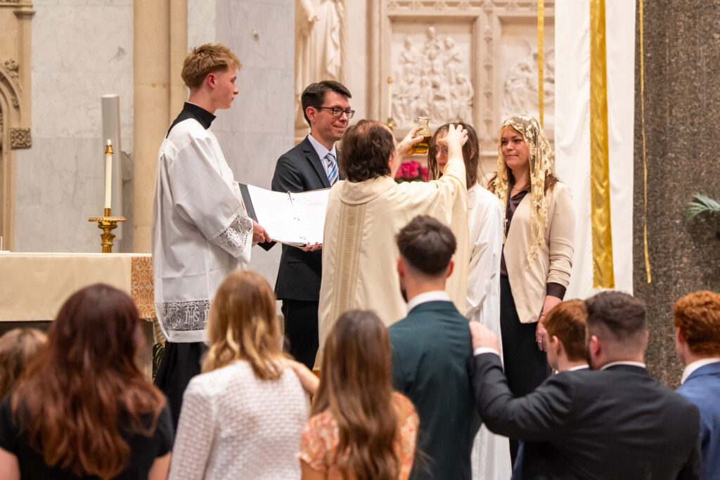 Maddie Janecek being confirmed on the altar of the Church of the Gesu.