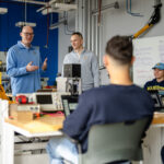 students and faculty collaborating in lab space