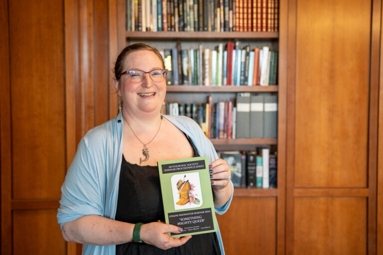 Grace Moone holds her publication featured in the Tolkien archives