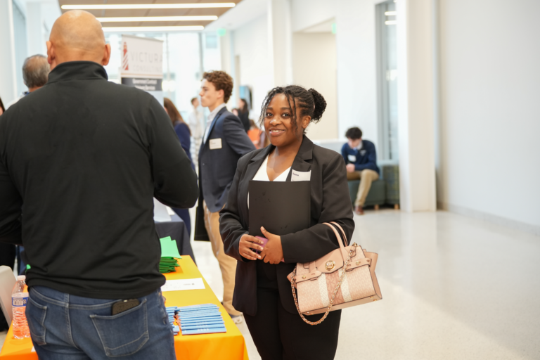 Marquette student connecting with employer at career fair